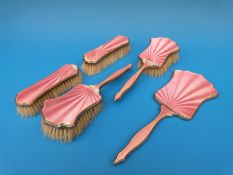 A hallmarked silver and pink guilloché enamel five-piece dressing table set comprising hand mirror