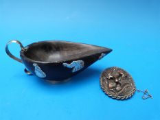 An Indian brooch depicting a monkey in the jungle with silver surround and photo compartment to the