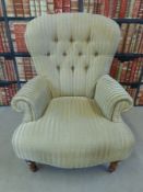 An upholstered button back armchair