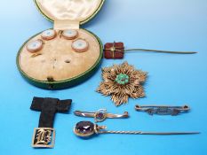 A 9ct gold brooch in the form of a flower set with turquoise to the centre,