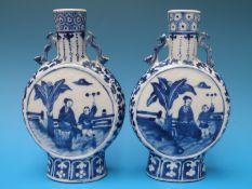 A pair of 19thC Chinese blue and white moon flasks decorated with court scenes and four character