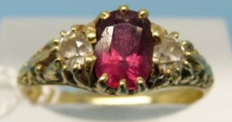 A yellow metal gold Victorian ring set with an oval cut ruby,