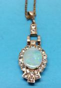 WITHDRAWN 
A yellow metal pendant set with a large opal surrounded by cubic zirconia