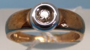 A 9ct gold and platinum ring set with a single diamond (size P)