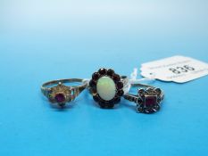 Two 9ct and silver rings, one set with an opal surrounded by red stones,