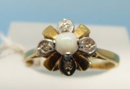 An 18ct gold ring set with a central opal and four diamonds in a flower cluster (size N)