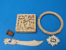 A Chinese carved ivory box containing a puzzle,