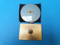 A Stratton RAF compact together with a musical compact