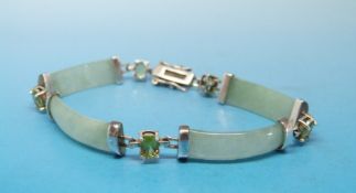 A silver bracelet set with jadeite and peridots