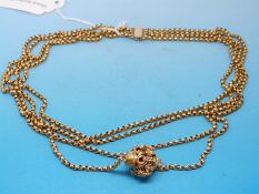 A gold necklace made up of four chains with decorative clasp (39.