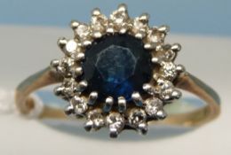 A 9ct gold ring set with a sapphire surrounded by diamonds (size P)