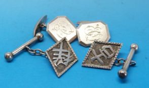 Two pairs of white metal cufflinks including an oriental pair