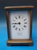 A French carriage clock in brass case 'Drew & Sons' Picadilly Circus, London W to dial,