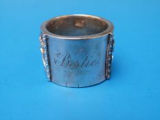 An Indian white metal napkin ring with embossed decoration of fish and other sea life 57g