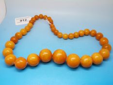 An amber necklace consisting of 37 graduated spherical beads, the largest measuring 2.
