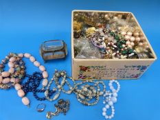 A collection of costume jewellery to include beads, brooches,