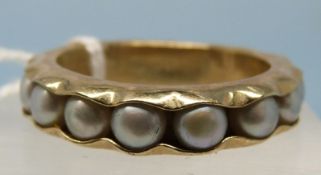 A 9ct gold ring set with pearls around the band (size P)