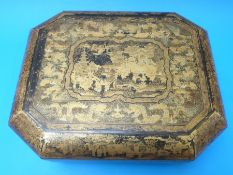 A 19thC Chinese lacquer games box, the exterior decorated in gilt with various Chinese scenes,