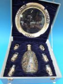 A Chinese white metal and glass cased decanter tray and tot holders.