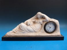 A mid to late 19th century alabaster figural mantel clock in the form of a reclining lady with