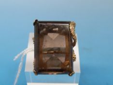 A 9ct gold ring set with a large smoky quartz in a textured gold setting