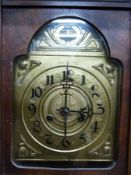 A c1910 two train wall clock with brass dial and embossed pendulum,