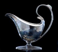An Arts and Crafts silver sauce boat by Omar Ramsden and Alwyn Carr (Ldn 1907) lightly hammered