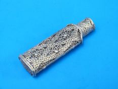 A white metal filigree scent bottle with glass bottle,