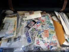 A suitcase containing a large quantity of loose stamps,