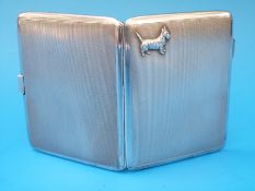 A hallmarked silver cigarette case with relief decoration of a Scottie dog,