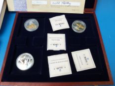 Six 50mm 'Portraits of The Queen' coins in a case with certificates
