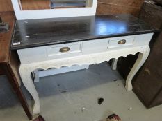 A carved and painted French style dressing table with two drawers on cabriole legs (W109 x D44 x