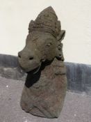 An Indonesian carved volcanic sculpture fragment of a horse headed goddess (height 70cm)