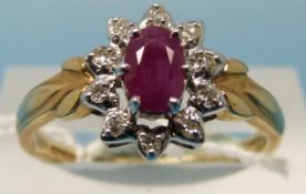A 14ct gold ring set with a ruby surrounded by diamonds (size Q)