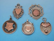 Five silver watch fobs with gold embellishments with sporting interest