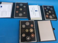 Three UK proof coin collections by the British Royal Mint in deluxe cases comprising 1986,