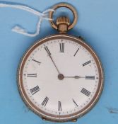 A yellow metal pocket watch with ornate engraving, enamel face and Roman numerals,