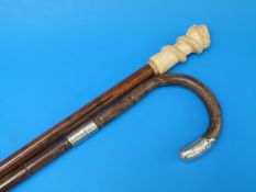 A walking cane with marine ivory handle in the form of a snake held in fist,