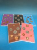 Five Royal Mint UK brilliant coin sets in perspex cases 1970-1974,
