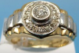 An 18ct gold ring set with a round brilliant cut diamond surrounded by smaller diamonds (size T,