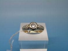 An 18ct gold ring set with a round brilliant cut diamond measuring 0.