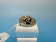 A 9ct gold ring set with diamonds in a twist setting (total 0.