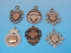 Six various silver watch fobs all with gold embellishment