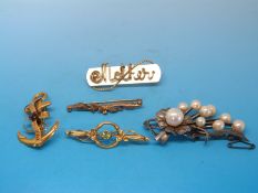 A 15ct gold brooch set with seed pearl and peridot, a yellow metal brooch marked 9ct,
