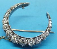 A Victorian gold and platinum crescent shaped metamorphic brooch set with 19 old cut diamonds,