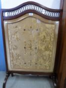 A 19thC silk embroidered fire screen with pierced decoration to top,