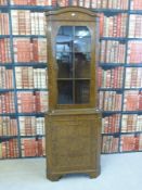 A glazed walnut corner cupboard,