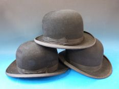 Three bowler hats with leather interior rims in three different sizes - one marked 6 3/4