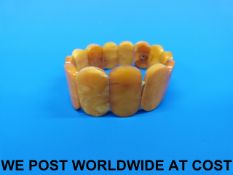 An amber bracelet consisting of 13 large oval sections of flattened form (20g)