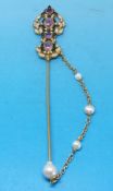 A Diego Percossi Papi designer stick pin set with seed pearls and amethysts amid green and purple